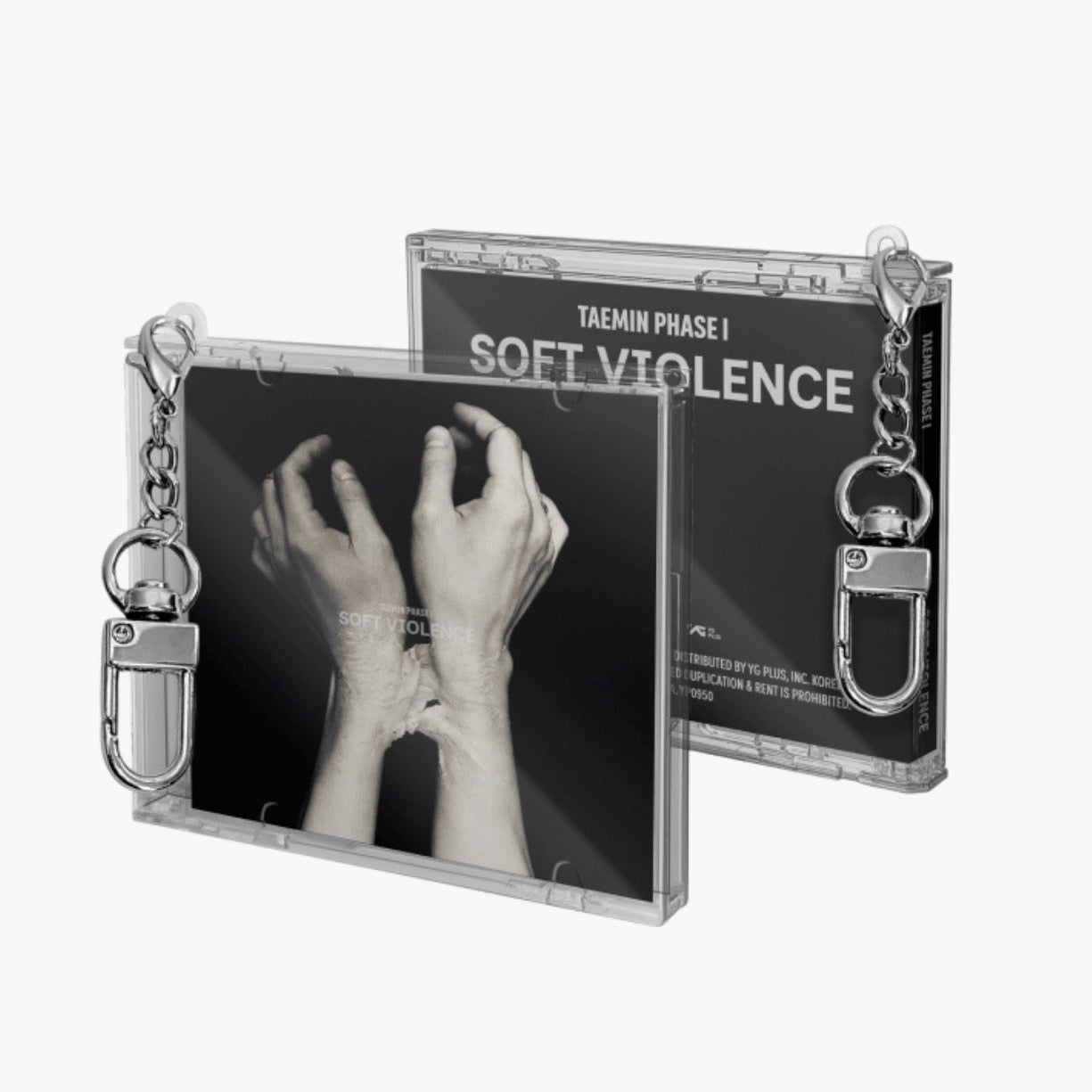 Two clear plastic CD-style cases with metal keychains, shown on a light gray background. The front case displays a black-and-white photo of crossed hands, and the back case shows the text 'TAEMIN  PHASE I SOFT VIOLENCE'.